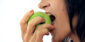 Woman Eating Green Apple