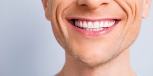 Close up cropped half face portrait of attractive, trendy, stylish, experienced, brunet, toothy man with wide beaming smile and healthy teeth